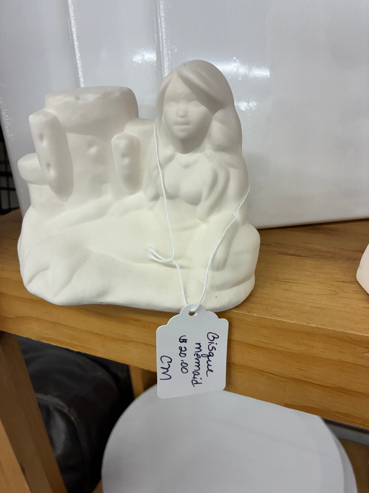 Ceramic bisque laying down mermaid