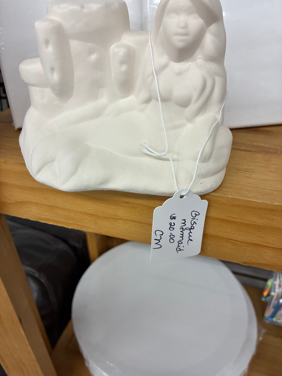 Ceramic bisque laying down mermaid